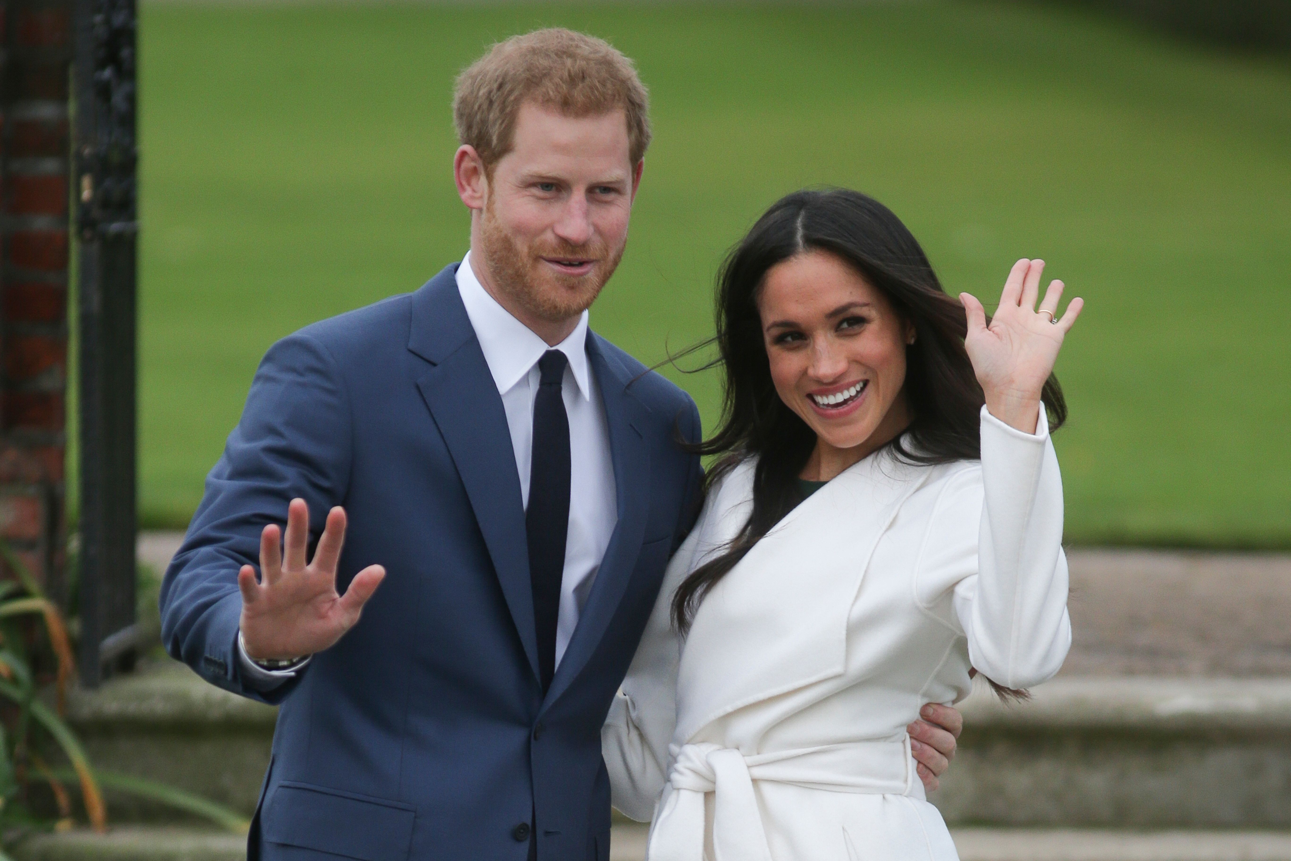 Britain's Prince Harry and his fiancée US actress Meghan Markle pose for a photograph in the Sunken Garden at Kensington Palace in west London on November 27, 2017, following the announcement of their engagement. Britain's Prince Harry will marry his US actress girlfriend Meghan Markle early next year after the couple became engaged earlier this month, Clarence House announced on Monday. / AFP PHOTO / Daniel LEAL-OLIVAS (Photo credit should read DANIEL LEAL-OLIVAS/AFP/Getty Images)